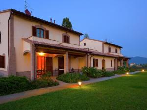 a large white house with a green lawn at Villa in Cannara with Pool near Assisi in Tordandrea