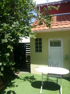 a white table in front of a house with a white door at Chambre cosy in Rezé