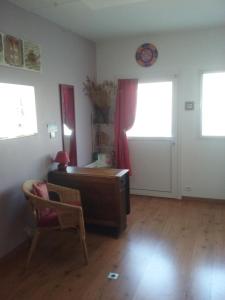 a living room with a piano and a chair at Chambre cosy in Rezé