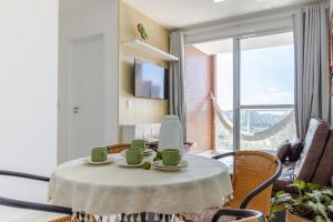 a room with a table with cups on it at Varanda c/ Rede • Vista Mar • 8º Andar NOMDS in Itaparica