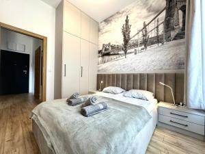 a bedroom with two beds and a painting on the wall at Michalczyka 3A - Self Check-In 20h - Parking in Wrocław
