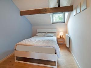 a bedroom with a white bed in a attic at Scenic Stay in Xhoffraix in Xhoffraix