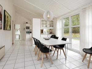 a kitchen and dining room with a table and chairs at Luxury Retreat with Pool - By Traum Ferienwohnungen in Grønhøj
