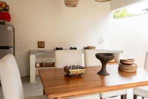 a kitchen with a wooden table with a counter top at Villa Budalipir - Uluwatu Bali in Uluwatu