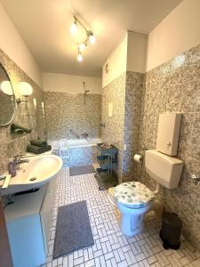 a bathroom with a toilet and a sink and a tub at Strandbude 4 in Dahme
