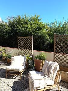 a patio with two chairs and some plants at Strandbude 4 in Dahme