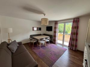 a living room with a couch and a table at Appartements Luna in Schladming