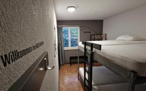 a room with two bunk beds and a window at Ski Und Gruppenhaus in Alt Sankt Johann