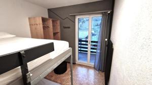 a room with two bunk beds and a window at Ski Und Gruppenhaus in Alt Sankt Johann