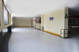 an empty hallway of a building with aexit sign on the wall at Hotel Seoul in Mexico City