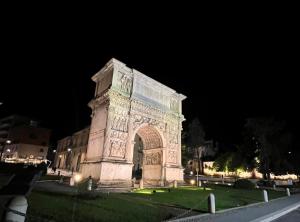 a large monument in the grass at night at Cenaculum Atticae Trajan in Benevento