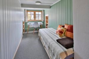 a bedroom with a bed and a desk in it at Haus Zum Reh in Krummenau