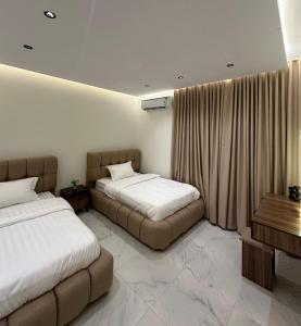 a hotel room with two beds and a window at Dar ASEEL دار أصيل in Jeddah +13 photos