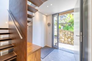 a hallway with a staircase and a door to a stone wall at Malvaglia in Malvaglia