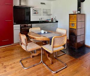 a kitchen with a table and chairs in a kitchen at 1,5 Zimmer Ferienwohnung in Luzern +6 photos