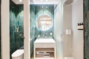 a bathroom with a sink and a mirror at Coeo Frailes Design Apartments in Málaga