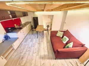 a living room with a couch and a kitchen at Stay Inn Central Cluj in Cluj-Napoca +3 photos