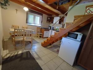 a kitchen and dining room with a table and a microwave at Agroturystyka Skała i Las - Noclegi Beskid Niski in Nowy Żmigród