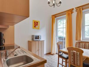 a kitchen with a sink and a table at Apartment Grossarl near Ski Slopes in Grossarl