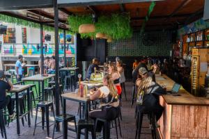 a group of people sitting at tables in a restaurant at Wild Rover Huacachina in Ica