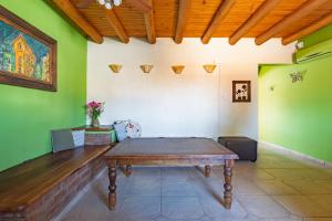 a dining room with a wooden table and green walls at Complejo Abaurrea in Mendoza