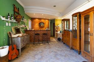 a kitchen with green walls and a counter with a guitar at Complejo Abaurrea in Mendoza +58 photos