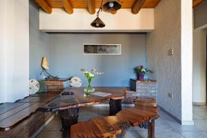 a dining room with a wooden table and benches at Complejo Abaurrea in Mendoza