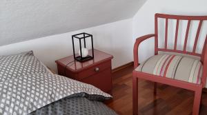 een slaapkamer met een bed en een nachtkastje met een lamp bij Ferienhaus Rosengarten in Selb
