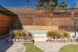 a backyard with a wooden fence and a swimming pool at Complejo Abaurrea in Mendoza