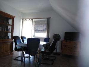 a dining room with a table and chairs and a window at Ferienwohnung mit Pool, WLAN direkt am See 70qm in Józseftelep