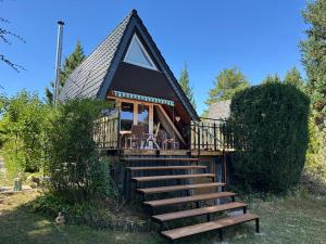 a cabin with stairs leading up to a house at Ferienhaus im Feriendorf Freilingen (Eifel). in Freilingen