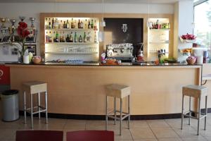 a kitchen with a bar with stools in a room at EuroHotel in Cesenatico