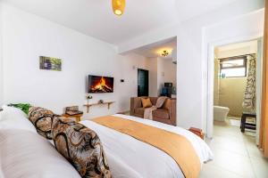a bedroom with a bed and a living room at Lorien Homes in Nairobi