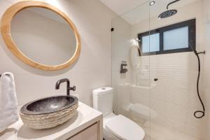a bathroom with a sink and a toilet and a mirror at Flamingo Marina Private Beachfront Escape in Playa Flamingo +18 photos