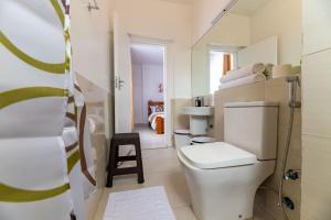 a bathroom with a white toilet in a room at Lorien Homes in Nairobi +111 photos