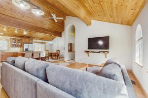 a living room with a couch and a tv at The Tahoe House in Truckee