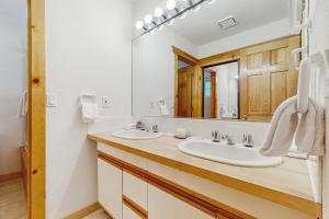 a bathroom with two sinks and a large mirror at The Tahoe House in Truckee +18 photos