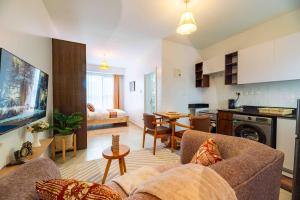 a living room with a couch and a kitchen at Lorien Homes in Nairobi
