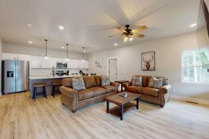 a living room with two couches and a kitchen at The Crossing at Lake Forest- 35 in Eagle River