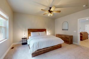 a bedroom with a bed and a ceiling fan at The Crossing at Lake Forest- 35 in Eagle River