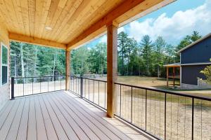 a screened porch with a view of the woods at The Crossing at Lake Forest- 35 in Eagle River