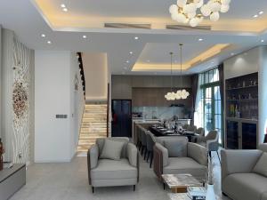 a kitchen and living room with a table and chairs at La isla Apartments & Villas - Sea View & Fireworks Phu Quoc in Phu Quoc