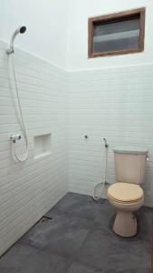 a bathroom with a toilet and a shower at Santalum Hotel Yogyakarta in Yogyakarta +25 photos