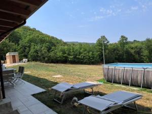a patio with chairs and a swimming pool at VILLA MILLEFIORI in Tornareccio