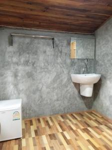 a bathroom with a sink and a mirror on the wall at Wooden House Koh Lanta in Ko Lanta Yai