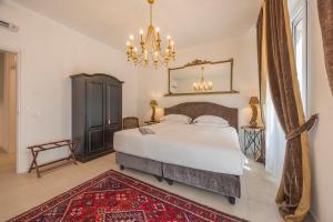 a bedroom with a large bed and a chandelier at Corte Realdi Suites Arena in Verona