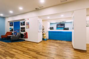 a lobby of a store with a counter and chairs at Travelodge Belfast in Belfast