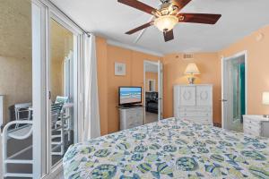 a bedroom with a bed and a ceiling fan at Oceania Plaza 808 in New Smyrna Beach +41 photos
