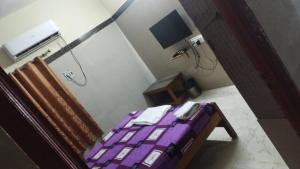 a room with a purple bed in a room at Green Parrk Hotel Vellore in Vellore