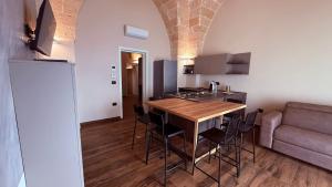 a kitchen and dining room with a table and chairs at Golden Suite Azzurra in Sava